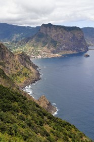 Portugal, Madeira Island, hike from Machico to Porto da Cruz by the Vereda do Larano, view of the bay of Porto da Cruz overlooked by the Eagle Rock (Penha d'Aguia)