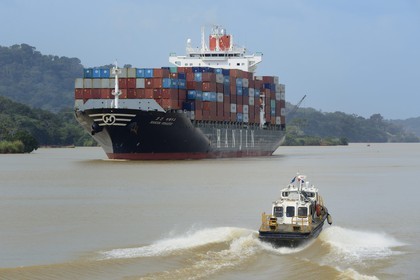 Panama, Panama Canal at Gamboa, Korean Panamax container cargo and pilote boat