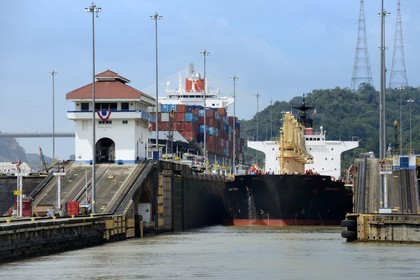 Panama, Panama Canal, Pedro Miguel locks, mechanical mules or electric locomotives guiding a Panamax cargo between the lock walls