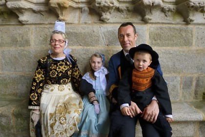 France, Finistere, Locronan, labelled Les plus Beaux Villages de France (The Most Beautiful Villages of France), family in traditional costumes under the porch of Saint Ronan church the day of the procession of the Tromenie