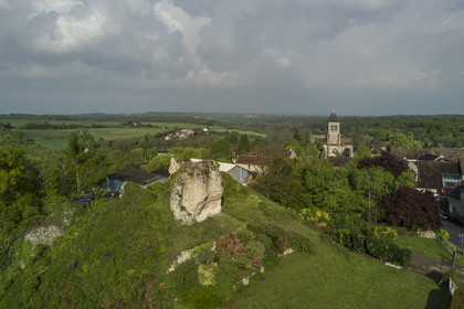 France, Yvelines, Montchauvet, ruins of the castle dungeon built in 1136 by Amaury de Montfort and Sainte Marie Madeleine (St. Mary Magdalene) church in the background