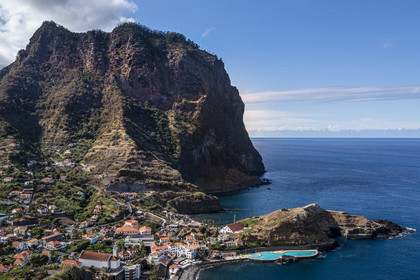 Portugal, Madeira Island, hike from Machico to Porto da Cruz by the Vereda do Larano, the bay of Porto da Cruz overlooked by the Eagle Rock (Penha d'Aguia) (aerial view)