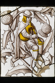 France, Paris, Musée de Cluny - Musée national du Moyen-Age (Middle Ages Museum in the former Hotel de Cluny), stained glass representing a bagpipe player, France circa 1500