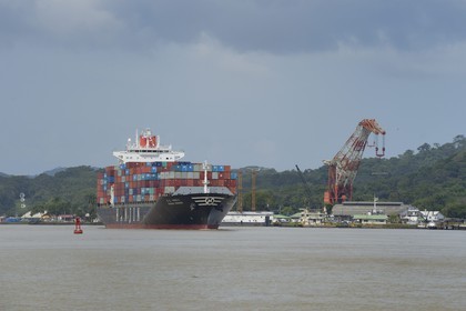 Panama, Panama Canal at Gamboa, Korean Panamax container cargo, Titan crane built by Nazi Germany in the background