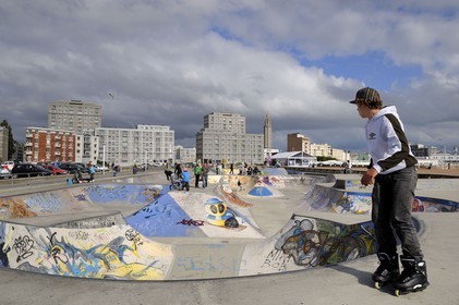 France, Seine Maritime, Le Havre, Downtown rebuilt by Auguste Perret listed as World Heritage by UNESCO, the Skate park on the beach, Perret buildings of Porte Océane (Ocean Gate) and St. Joseph's Church in the background