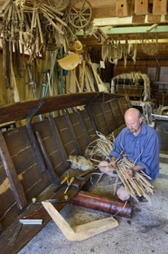France, Bas Rhin, Muttersholtz, the Ried, the boatman Patrick Unterstock repairing a small flat wooden bottom boat