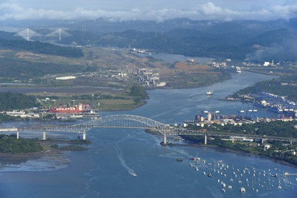 Panama, Panama City, the Bridge of the Americas (Puente de las Americas) over the Panama Canal access channel on the Pacific Ocean side, the Miraflores Locks in the background (aerial view)