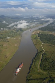 Panama, Panama Canal, a Panamax container cargo uses the Gaillard cut (or Culebra cut) between the Pedro Miguel locks on the Pacific side and the Chagres river leading to Gatun Lake (aerial view)