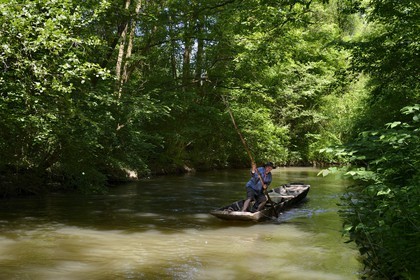 France, Bas Rhin, Ebersmunster and Muttersholtz region, the Ried, the boatman Patrick Unterstock in a small flat wooden bottom boat on the Ill river