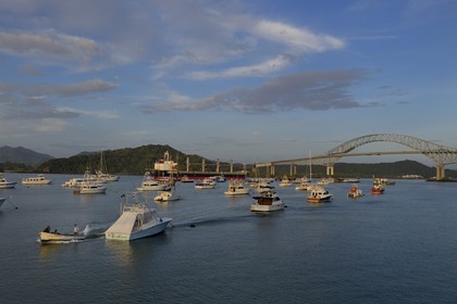 Panama, Panama City, Panama Canal access channel on the Pacific Ocean side, a Panamax cargo passing under the Bridge of the Americas (Puente de las Americas)