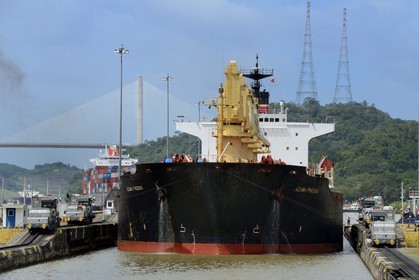 Panama, Panama Canal, Pedro Miguel locks, mechanical mules or electric locomotives guiding a Panamax cargo between the lock walls