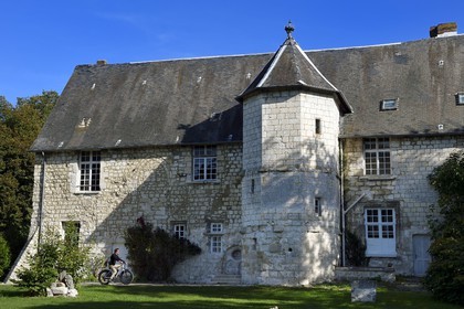 France, Seine-Maritime, Norman Seine River Meanders Regional Nature Park, Ambourville, cyclist in front of the manor of the Templars