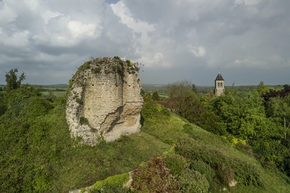 France, Yvelines, Montchauvet, ruins of the castle dungeon built in 1136 by Amaury de Montfort and Sainte Marie Madeleine (St. Mary Magdalene) church in the background