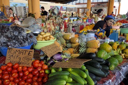 France, Mayotte island (French overseas department), Grande-Terre, Mamoudzou, large central market at the port, Mahorais women wearing a facial mask with sandalwood (the m'sindzano) behind their fruits and vegetables stalls