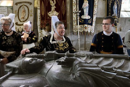 France, Finistere, Locronan, labelled Les plus Beaux Villages de France (The Most Beautiful Villages of France), women in traditional costume during the Tromenie around the cenotaph of St Ronan in Peniti chapel adjacent to the Saint Ronan church
