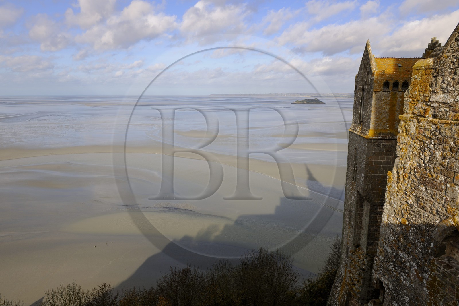 France, Manche, the abbey of Mont Saint Michel, listed as World Heritage by UNESCO, the north buildings (cloister, the knights room) overlooking the bay at low tide