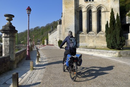France, Dordogne, Brantome, cyclists traveling along the Flow Vélo cycle route in front of Saint Pierre benedictine abbey
