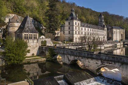 France, Dordogne, Brantome, cyclists traveling along the Flow Vélo cycle route crossing the Pont Coude (angled bridge) over Dronne River, Saint Pierre benedictine abbey in the background (aerial view)